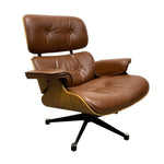 Load image into Gallery viewer, A mid-century modern lounge chair with brown leather upholstery, a curved wooden shell, and a black five-star base, photographed on a solid white background.

