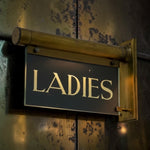 Load image into Gallery viewer, Vintage-style 'LADIES' sign on a textured wall
