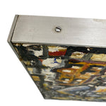 Load image into Gallery viewer, Close-up of a textured surface with abstract patterns and a metallic frame.
