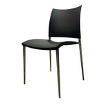 Load image into Gallery viewer, A modern black dining chair with a curved seat and backrest, supported by slim metallic legs, shown against a plain white background.
