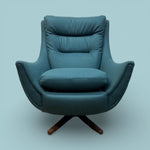 Load image into Gallery viewer, Blue armchair with wooden base on a light blue background
