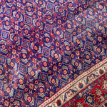 Load image into Gallery viewer, Close-up of a patterned rug with intricate designs.
