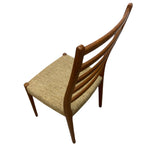 Load image into Gallery viewer, Wooden chair with a woven seat on a white background
