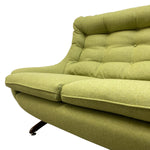 Load image into Gallery viewer, A close-up of a mid-century modern sofa upholstered in textured olive green fabric, featuring a tufted backrest and a curved armrest, shown against a plain white background.
