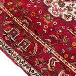 Load image into Gallery viewer, Close-up of a red patterned rug with intricate designs
