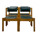 Load image into Gallery viewer, Four wooden dining chairs arranged in a 2x2 grid, featuring warm medium-brown wood frames and dark teal padded seat and back cushions, shown against a plain white background.
