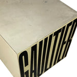 Load image into Gallery viewer, A close-up of a metallic box or container corner with a brushed silver top and side panel featuring large black vertical lettering that reads 'GAULIER' on a white background.
