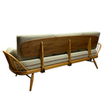 Load image into Gallery viewer, Sofa bed with wooden frame and beige cushions on a white background
