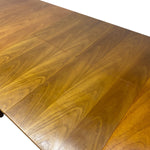 Load image into Gallery viewer, Close-up of a wooden table surface with visible wood grain and a fold-out leaf design, photographed against a white background.
