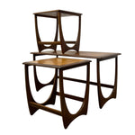 Load image into Gallery viewer, Three nested wooden nesting tables with a mid-century modern design, featuring curved supports and a rich dark brown wood finish, shown on a plain white background.
