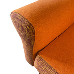 Load image into Gallery viewer, Close-up of an orange fabric armchair corner on a white background
