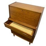 Load image into Gallery viewer, Mid-century modern wooden writing desk with a warm medium-brown wood finish, featuring an open top drawer, a lower drawer with a cork mat, and curved metal handles, shown on a white background.
