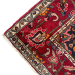 Load image into Gallery viewer, Close-up of a red patterned rug with intricate designs on a white background
