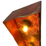 Load image into Gallery viewer, Triangular metal wall sconce with a warm orange crackled glass panel and a glowing light bulb, shown against a white background.
