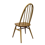 Load image into Gallery viewer, A single wooden dining chair with a curved spindle-back design, shown from a three-quarter angle against a plain white background.

