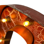 Load image into Gallery viewer, Close-up of a rustic metal light fixture with a reddish-brown distressed finish, white crackle pattern, and glowing warm yellow bulbs.
