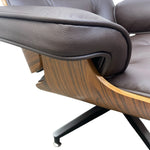 Load image into Gallery viewer, Close-up of a mid-century modern lounge chair with dark brown pebbled leather upholstery and a curved wood shell base on a white background.
