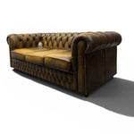 Load image into Gallery viewer, Brown leather sofa with tufted backrest on a white background
