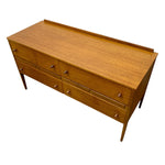 Load image into Gallery viewer, Mid-century modern wooden sideboard or credenza with six drawers, a warm honey-wood finish, and small round metal pulls, shown on a plain white background.
