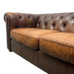 Load image into Gallery viewer, Brown leather sofa with tufted backrest on a white background
