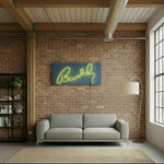 Load image into Gallery viewer, Modern living room with a gray sofa, brick wall, and neon sign.

