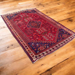 Load image into Gallery viewer, Decorative rug with intricate patterns on a wooden floor
