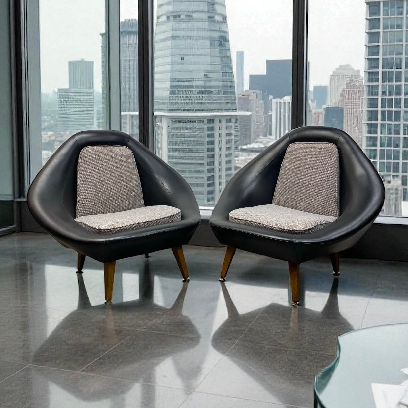 Two modern black chairs with gray cushions in front of a city skyline view.