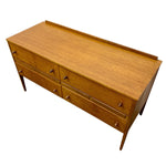 Load image into Gallery viewer, Mid-century modern wooden sideboard with six drawers, a warm honey-wood finish, and small round metal pulls, shown on a plain white background.
