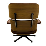 Load image into Gallery viewer, A mid-century modern lounge chair with a wood-grain upholstered shell, brown leather cushions, and a black five-star base, shown from the back against a white background.
