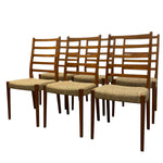 Load image into Gallery viewer, Set of six wooden chairs with woven seat cushions on a white background
