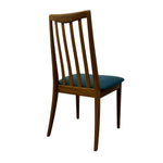 Load image into Gallery viewer, A mid-century modern wooden dining chair with a slatted backrest and a teal blue upholstered seat cushion, shown from a three-quarter angle against a plain white background.
