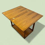Load image into Gallery viewer, Wooden table with a light green background
