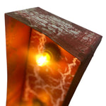 Load image into Gallery viewer, A close-up of a rectangular metal container or lamp-like object with a distressed reddish-brown exterior and a glowing warm orange interior, shown against a plain white background.
