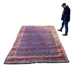 Load image into Gallery viewer, Large patterned rug on a white background with a person standing nearby.

