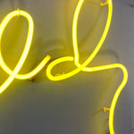 Load image into Gallery viewer, Neon yellow sign on a white background
