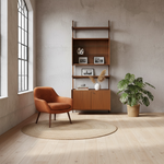 Load image into Gallery viewer, Modern interior with a wooden armchair, bookshelf, and plant in a room with large windows.
