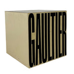 Load image into Gallery viewer, A square decorative box with a beige or cream-colored exterior and bold black 'GAULTIER' lettering printed on the front, shown against a plain white background.

