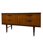 Load image into Gallery viewer, Mid-century modern wooden sideboard with four drawers, dark wood grain finish, and tapered legs, shown against a plain white background.
