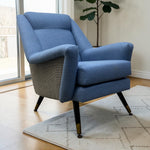Load image into Gallery viewer, midcentury blue wool chair in a sitting room with plant and rug
