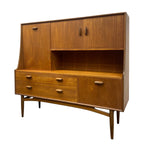 Load image into Gallery viewer, Mid-century modern wooden hutch cabinet with a warm medium-brown wood grain finish, featuring two upper doors, an open central shelf, two lower drawers, and two side drawers on a tapered wooden stand.
