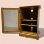 Load image into Gallery viewer, Wooden cabinet with open doors on a beige background

