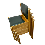 Load image into Gallery viewer, A stack of wooden nesting chairs with dark green upholstered seats and backs, shown on a plain white background.
