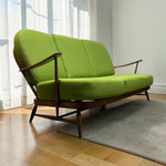 Load image into Gallery viewer, three seater sofa in green on a rug with a wooden floor
