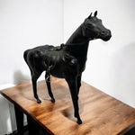 Load image into Gallery viewer, Black horse statue on a wooden table against a white wall
