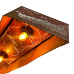 Load image into Gallery viewer, A close-up of a rectangular industrial-style light fixture with a distressed rusted metal frame and glowing warm orange light from two visible bulbs, shown against a plain white background.
