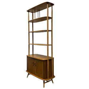 Wooden Ercol bookshelf with multiple shelves on a white background