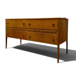 Load image into Gallery viewer, A mid-century modern wooden dresser with six drawers, featuring a warm medium-brown wood finish and small round metal pulls, shown on a white background with a soft shadow.
