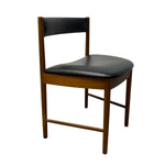 Load image into Gallery viewer, A mid-century modern wooden dining chair with a black leather upholstered seat and backrest, shown against a plain white background.
