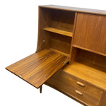 Load image into Gallery viewer, A mid-century modern wooden writing desk or cabinet with a pull-out desk surface, shown open against a plain white background.
