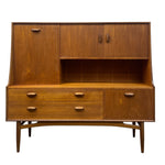 Load image into Gallery viewer, Mid-century modern wooden sideboard cabinet with a warm medium-brown wood grain finish, featuring two upper cabinet doors, an open central shelf, two lower drawers, one lower cabinet door, and tapered legs, shown on a plain white background.
